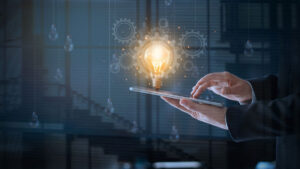 man holding lightbulb on tablet